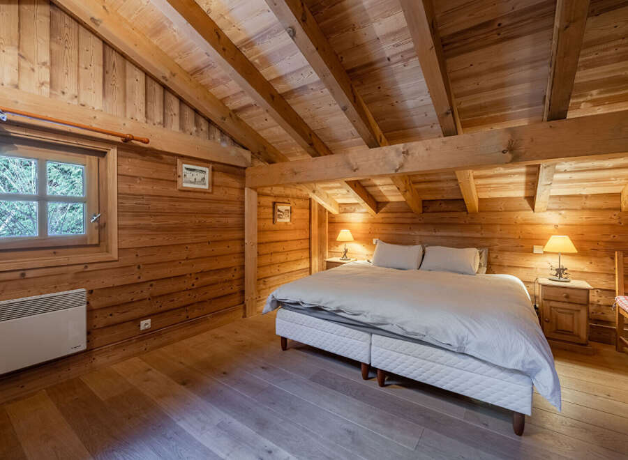 This cozy bedroom features a rustic wooden interior, creating a warm and inviting atmosphere.
