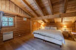 This cozy bedroom features a rustic wooden interior, creating a warm and inviting atmosphere.