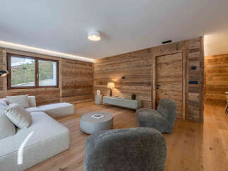 Experience the warmth of this stunning living space, featuring exquisite wood paneling that adds a touch of rustic elegance.