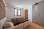 This cozy bedroom features a luxurious bed with a plush, brown fur throw, creating a warm and inviting atmosphere.