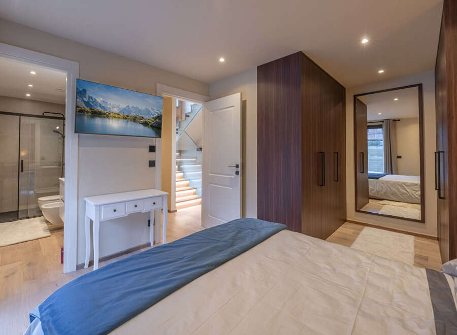 Step into luxury with this stunning bedroom featuring a modern design and high-end finishes.