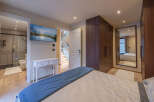 Step into luxury with this stunning bedroom featuring a modern design and high-end finishes.