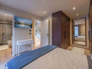 Step into luxury with this stunning bedroom featuring a modern design and high-end finishes.