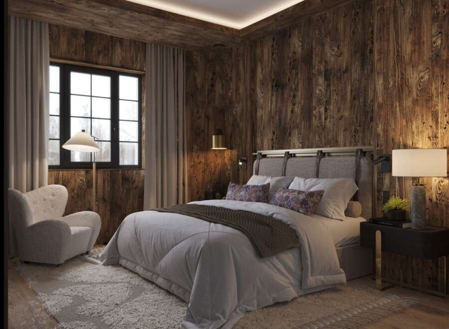 Experience rustic elegance in this stunning bedroom featuring rich wood paneling and a cozy ambiance.