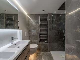 Step into luxury with this stunning bathroom featuring sleek marble tiles and modern fixtures.