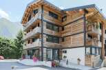 This stunning wooden chalet-style hotel offers a unique blend of rustic charm and modern comfort.