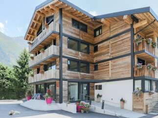 This stunning wooden chalet-style hotel offers a unique blend of rustic charm and modern comfort.