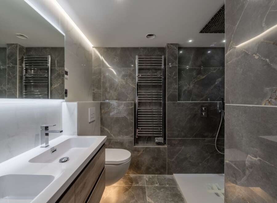 Step into luxury with this stunning bathroom featuring sleek marble tiles and modern fixtures.