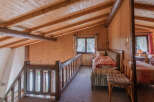 Discover the charm of this cozy loft space, featuring warm wooden accents and a rustic aesthetic.