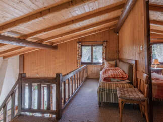 Discover the charm of this cozy loft space, featuring warm wooden accents and a rustic aesthetic.