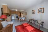 Discover this stylish apartment featuring a modern kitchen and a cozy living area.