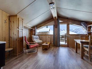 This charming chalet-style apartment offers a cozy and inviting atmosphere, perfect for a mountain getaway.