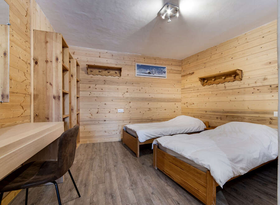 This cozy bedroom features a warm wooden interior, creating a rustic and inviting atmosphere.