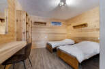 This cozy bedroom features a warm wooden interior, creating a rustic and inviting atmosphere.