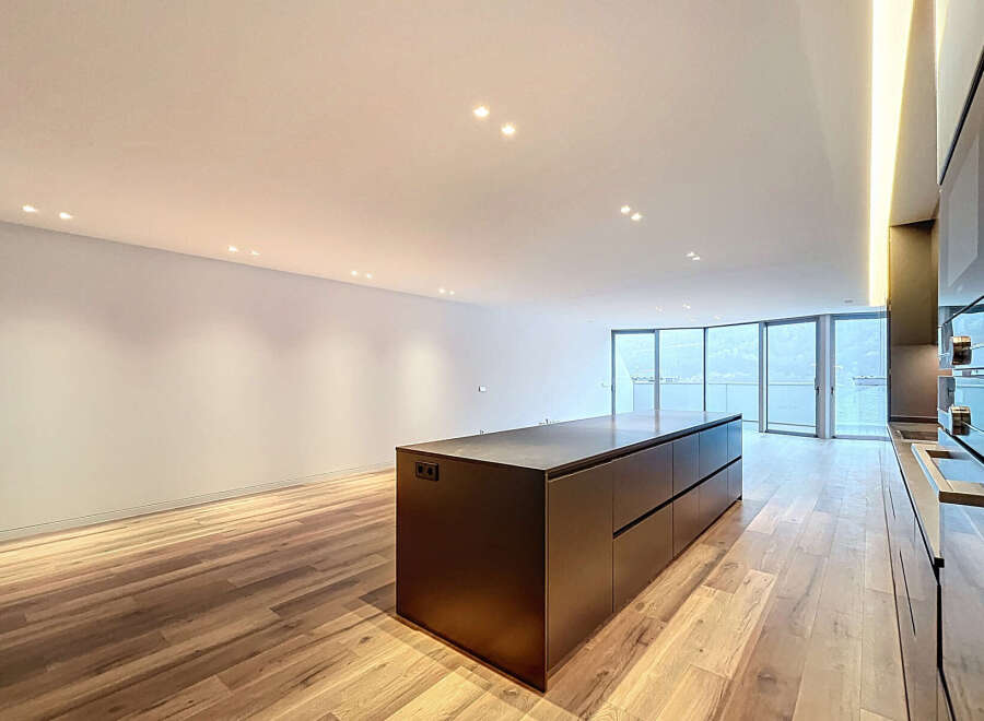 Experience modern luxury in this stunning kitchen! Featuring a sleek, dark-toned island and cabinetry, this space is perfect for both cooking and entertaining.