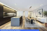 Experience modern luxury in this stunning property, featuring a sleek kitchen with a large island and high-end appliances.