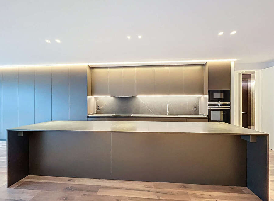 This modern kitchen boasts sleek, minimalist design with high-end finishes.