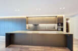 This modern kitchen boasts sleek, minimalist design with high-end finishes.