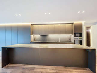 This modern kitchen boasts sleek, minimalist design with high-end finishes.