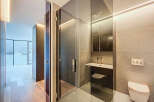 Step into luxury with this stunning bathroom, featuring a sleek glass shower enclosure and modern fixtures.