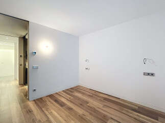 Discover the potential of this modern space! Featuring a blank canvas with pristine white walls and elegant wooden flooring, this property offers a versatile foundation for your design vision.