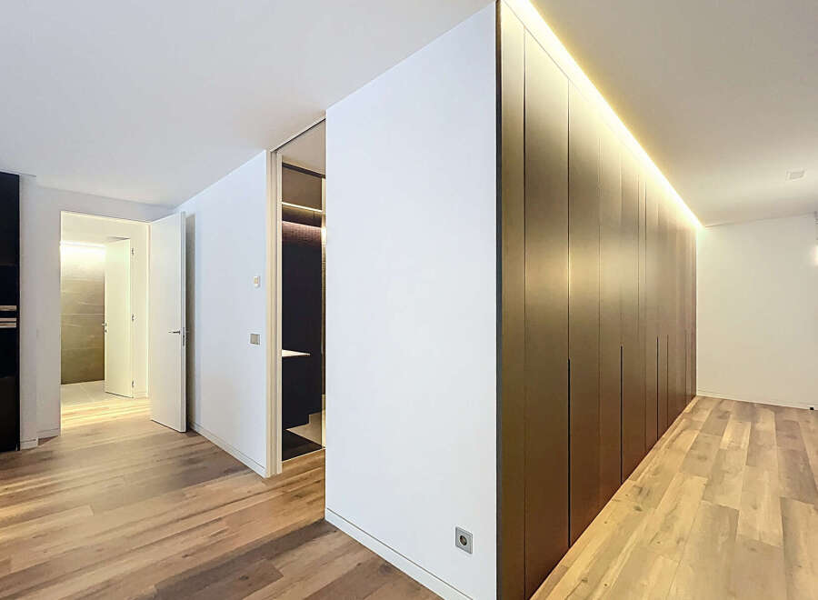 Discover modern elegance in this stunning property, featuring sleek, dark wood cabinetry and a warm, inviting ambiance.