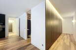 Discover modern elegance in this stunning property, featuring sleek, dark wood cabinetry and a warm, inviting ambiance.