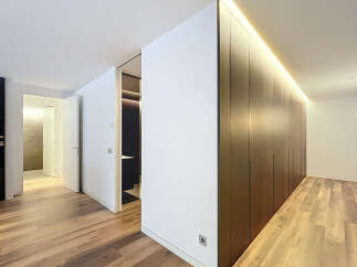 Discover modern elegance in this stunning property, featuring sleek, dark wood cabinetry and a warm, inviting ambiance.