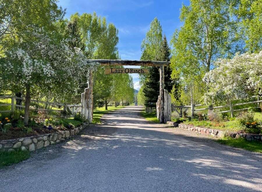 Welcome to the Lazy O Ranch, a stunning property with a grand entrance.