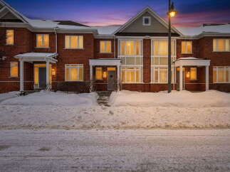 Discover this stunning townhome featuring a classic brick exterior and inviting curb appeal.