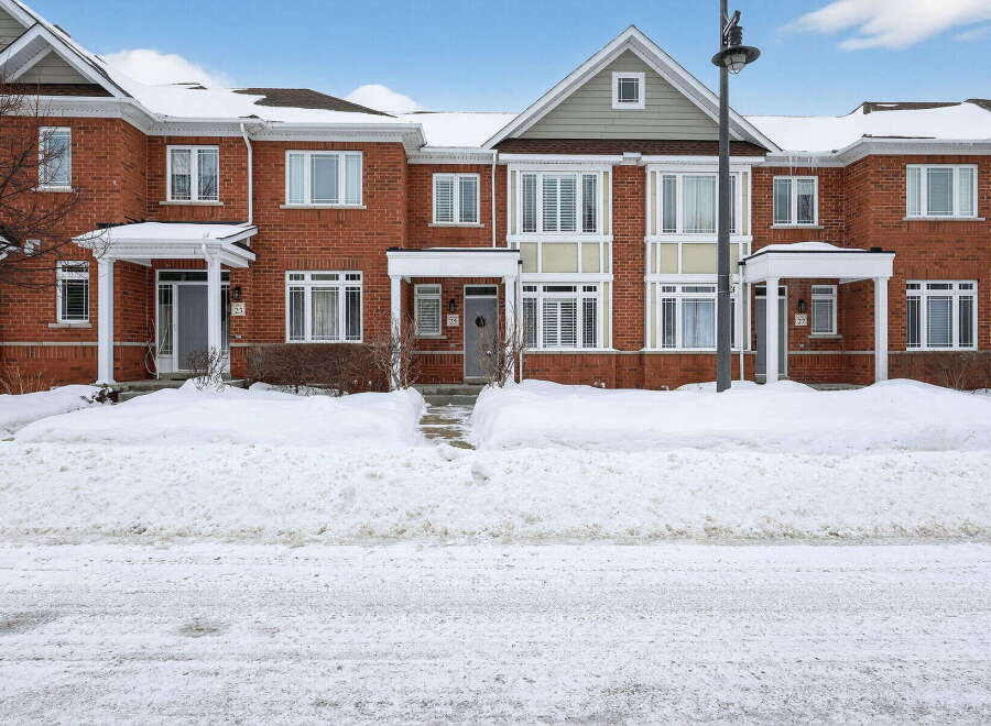 Discover this stunning townhouse, featuring a classic brick facade and inviting curb appeal.
