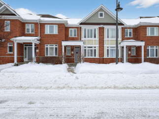 Discover this stunning townhouse, featuring a classic brick facade and inviting curb appeal.