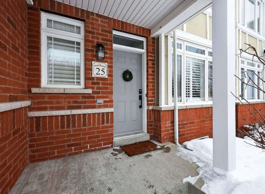 This charming property boasts a welcoming facade with a brick exterior and a well-maintained front porch.