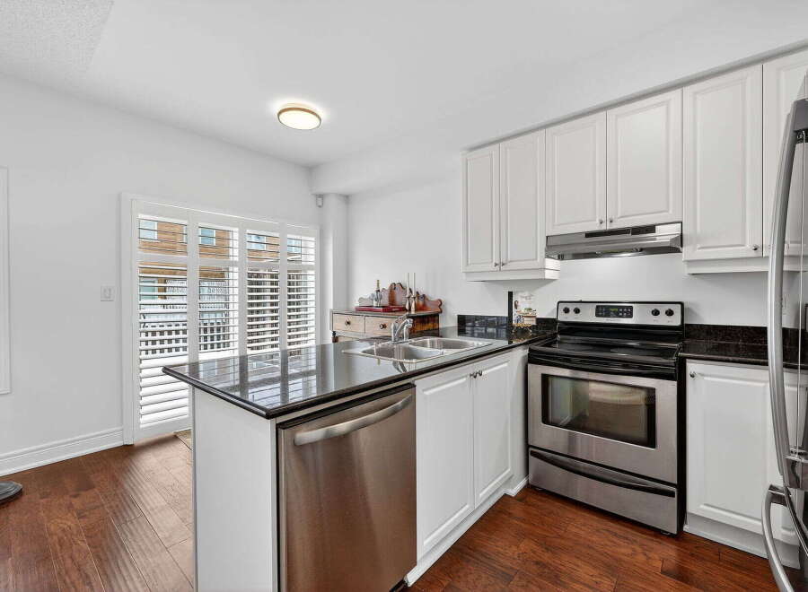This stunning kitchen boasts modern appliances and sleek countertops, perfect for culinary enthusiasts.