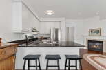 This stunning kitchen boasts sleek granite countertops, stainless steel appliances, and ample cabinet space, perfect for culinary enthusiasts.