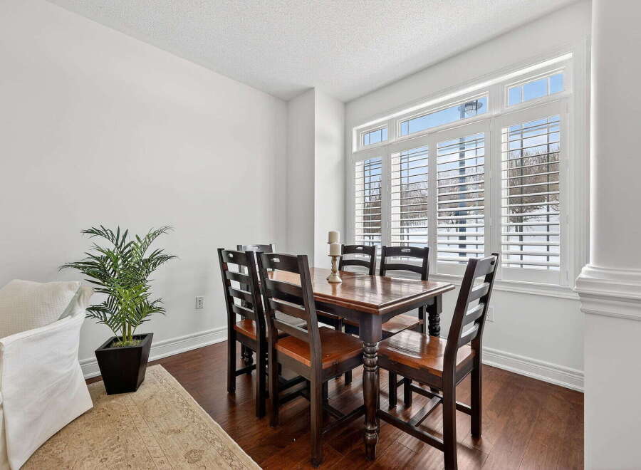 This stunning dining room boasts a warm and inviting atmosphere, perfect for hosting gatherings.