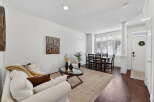 Step into this inviting living space, featuring a bright and airy ambiance with pristine white walls and elegant hardwood floors.
