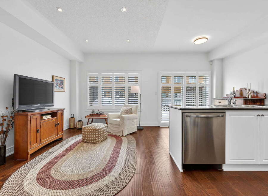 Step into this beautifully designed living space, featuring a cozy seating area and a modern kitchen.