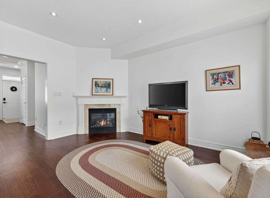 This stunning property boasts a cozy living room with a fireplace, perfect for those chilly evenings.