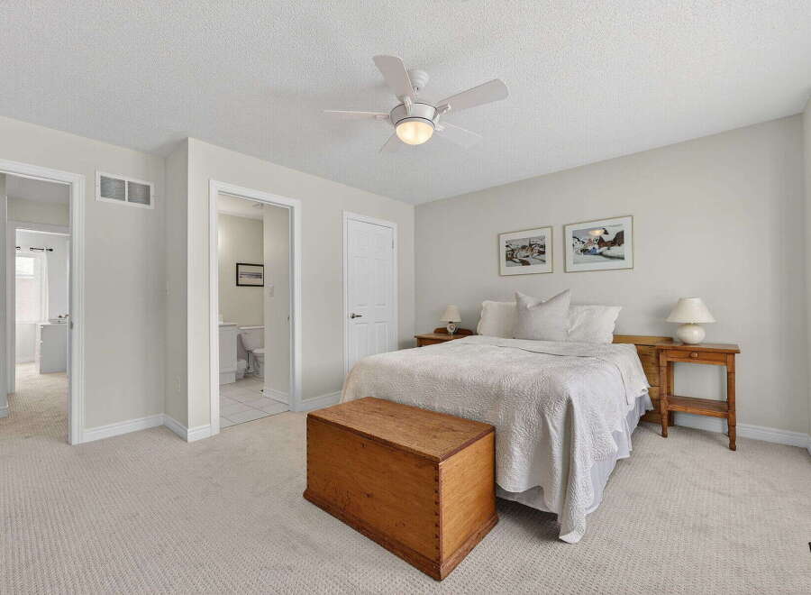 This inviting bedroom offers a serene retreat with its neutral color palette and ample natural light.