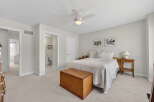 This inviting bedroom offers a serene retreat with its neutral color palette and ample natural light.