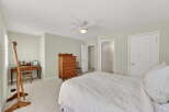 This inviting bedroom offers a serene retreat with its neutral color palette and ample natural light.