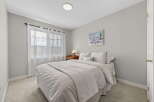 Step into this cozy bedroom, featuring a comfortable bed and soft bedding.