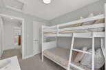 This charming bedroom features a cozy bunk bed, perfect for kids or guests.