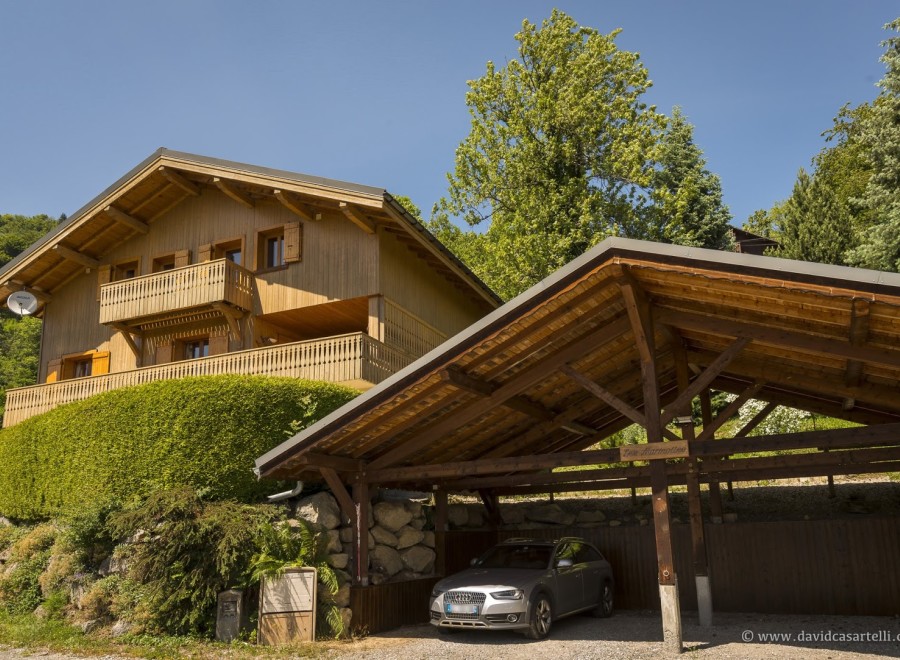 This charming chalet boasts a stunning wooden exterior, spacious balcony, and breathtaking mountain views.