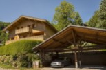 This charming chalet boasts a stunning wooden exterior, spacious balcony, and breathtaking mountain views.