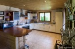 This charming kitchen boasts a rustic-chic design with wood accents and granite countertops.