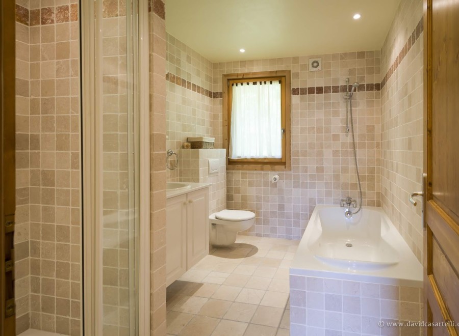 This stunning bathroom boasts a spacious bathtub and a separate shower enclosure, perfect for relaxation.