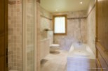 This stunning bathroom boasts a spacious bathtub and a separate shower enclosure, perfect for relaxation.