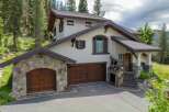 Discover luxury living in this stunning mountain retreat! This exquisite home boasts a beautiful stone facade, multiple garage spaces, and a charming covered entryway.